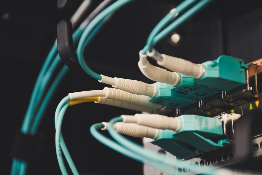 Close-up of fiber optic LC connectors patched into a panel